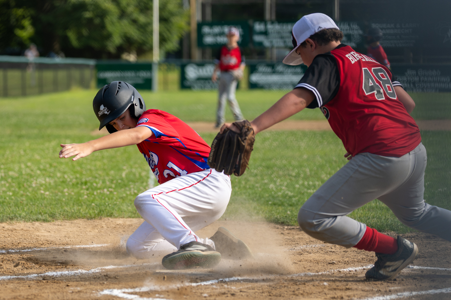 Jace Birdsall tries to stop a North Shore base runner from scoring.  RON ESPOSITO