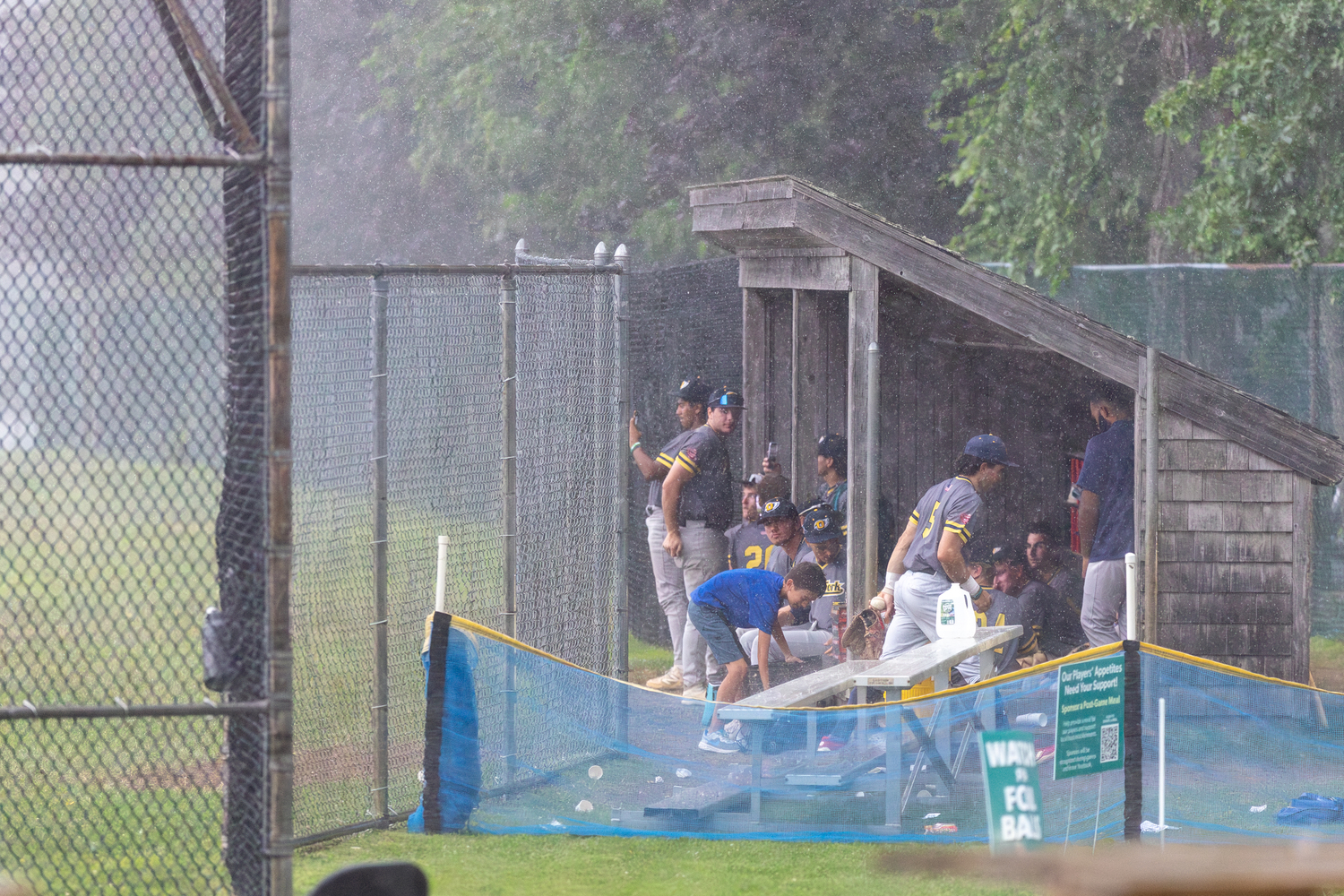 A deluge of rain at Mashashimuet Park in Sag Harbor on Friday led to a suspension of game two of the series that was picked up and finished the following day.  RON ESPOSITO