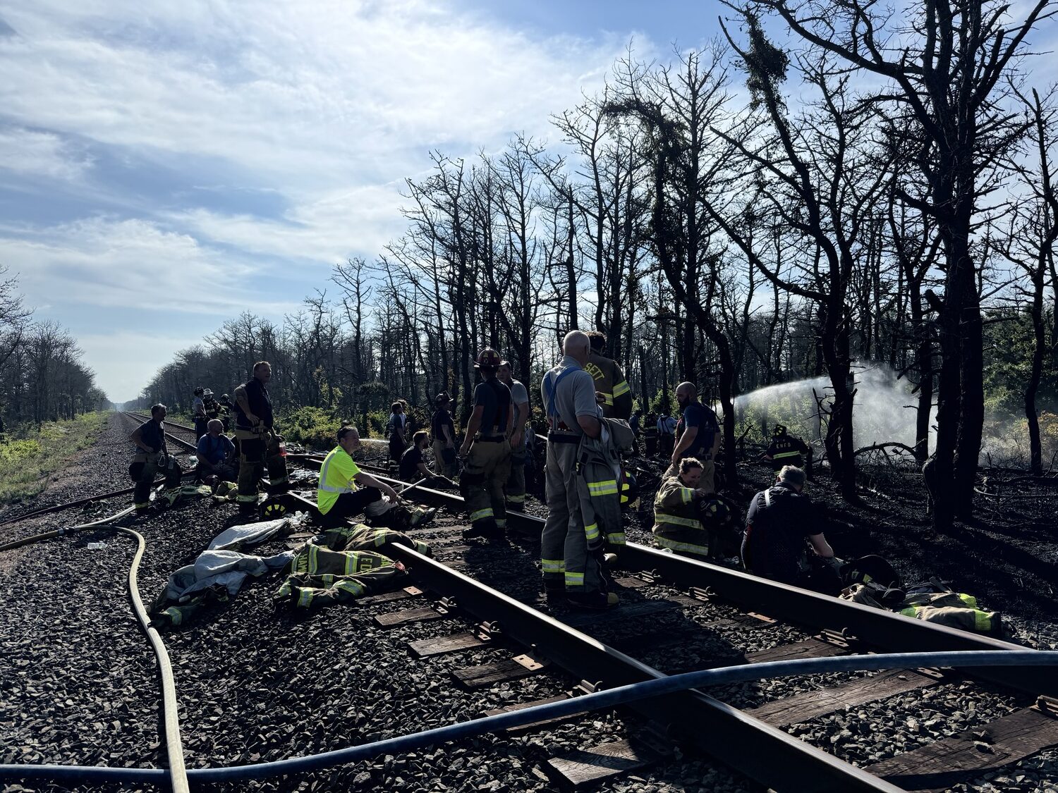 Fire fighters from several local departments have extinguished the brush fire and are now conducting mop up operations, searching for smoldering embers that could reignite the flames.