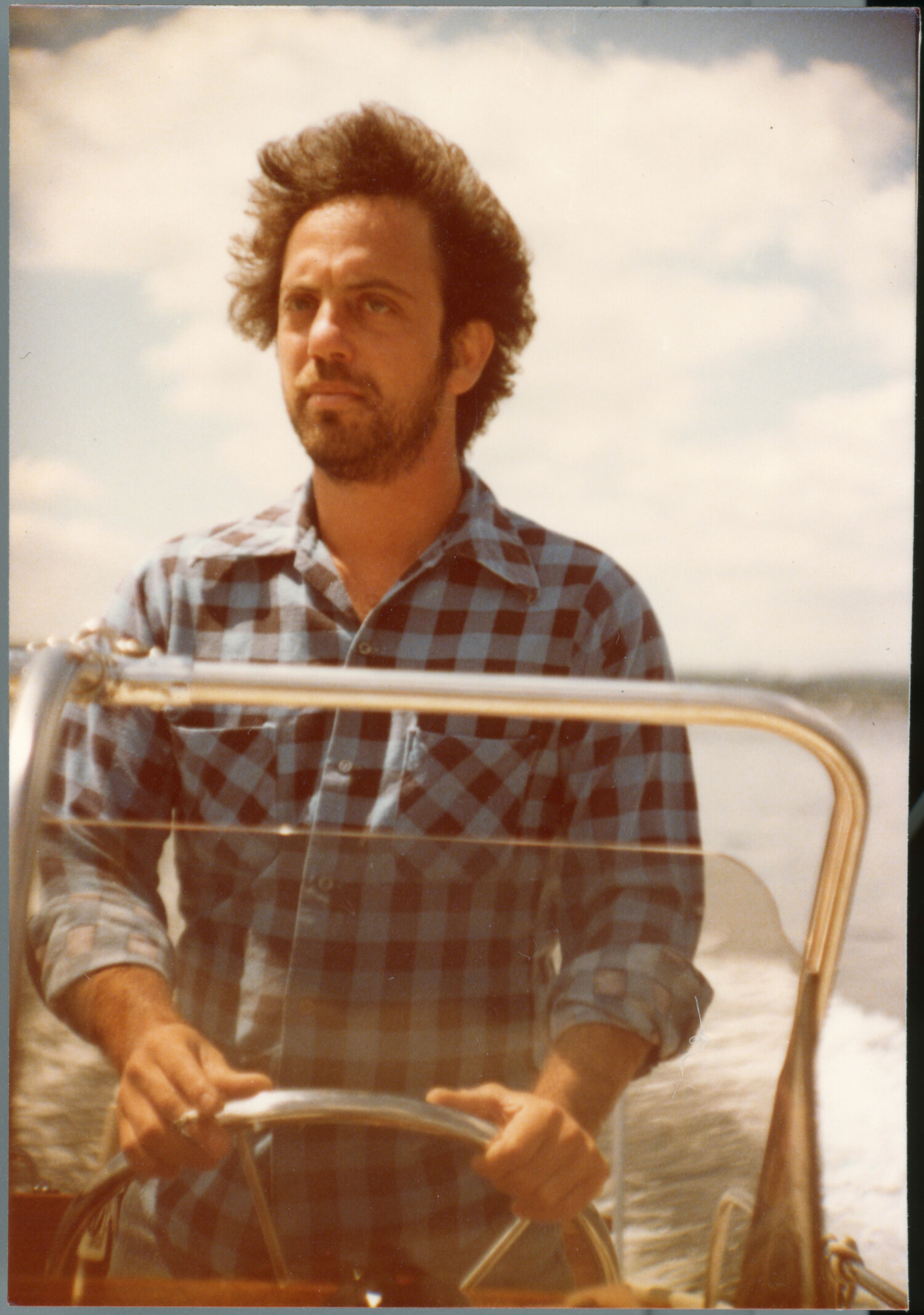 Billy Joel piloting a boat in a scene from the HBO documentary “Billy Joel: And So It Goes.” BILLY JOEL ARCHIVES