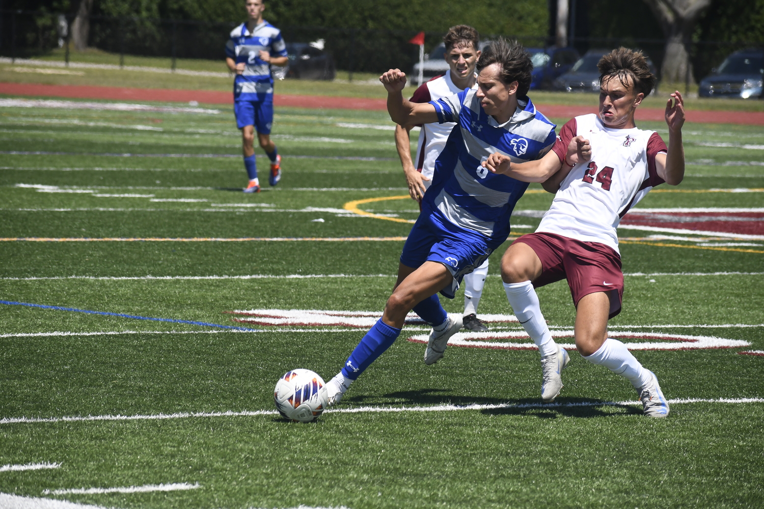 Fordham freshman Nick Mesquita cleanly slides tackles Seton Hall freshman Valentino Solari to jar the ball loose.  DREW BUDD