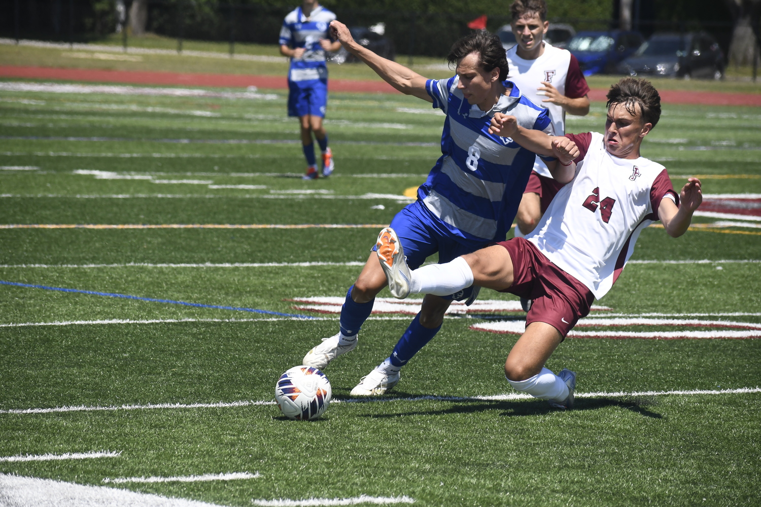Fordham freshman Nick Mesquita cleanly slides tackles Seton Hall freshman Valentino Solari to jar the ball loose.  DREW BUDD
