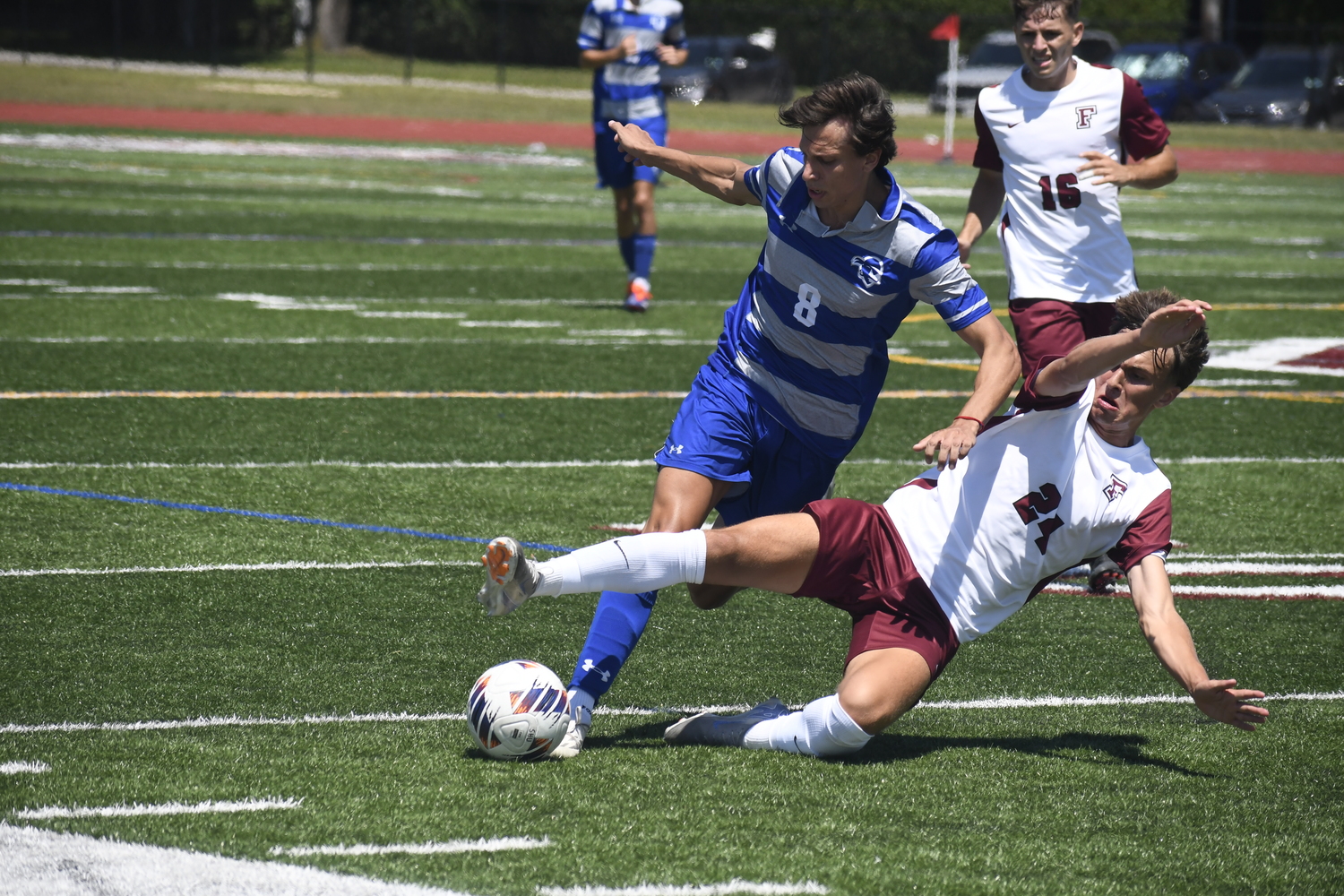 Fordham freshman Nick Mesquita cleanly slides tackles Seton Hall freshman Valentino Solari to jar the ball loose.  DREW BUDD