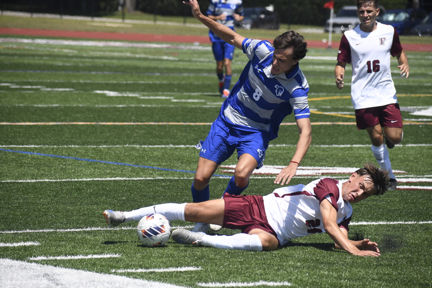 Fordham freshman Nick Mesquita cleanly slides tackles Seton Hall freshman Valentino Solari to jar the ball loose.  DREW BUDD