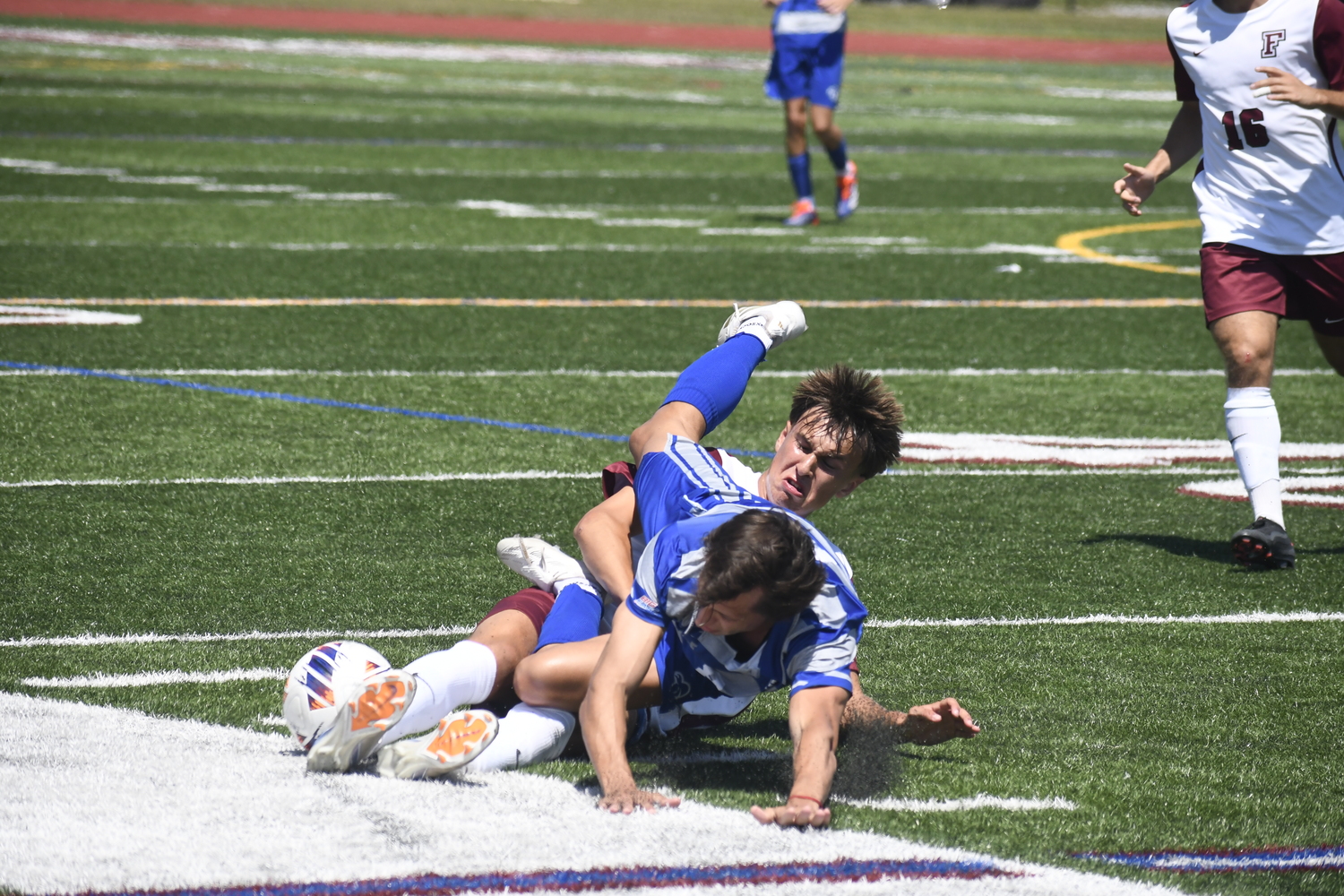 Fordham freshman Nick Mesquita cleanly slides tackles Seton Hall freshman Valentino Solari to jar the ball loose.  DREW BUDD