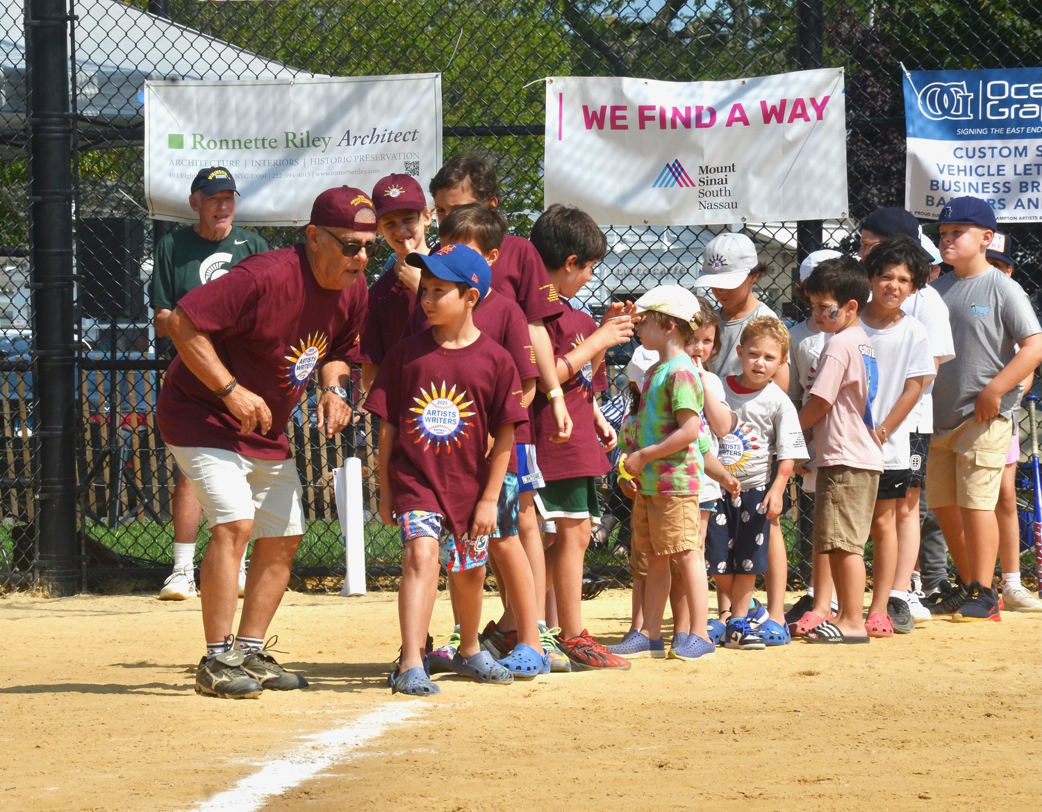 Mike Lupica gets set to lead the kids around the bases.  KYRIL BROMLEY