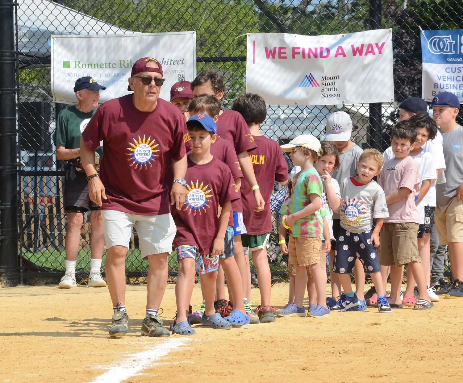 Mike Lupica leads the kids around the bases.  KYRIL BROMLEY