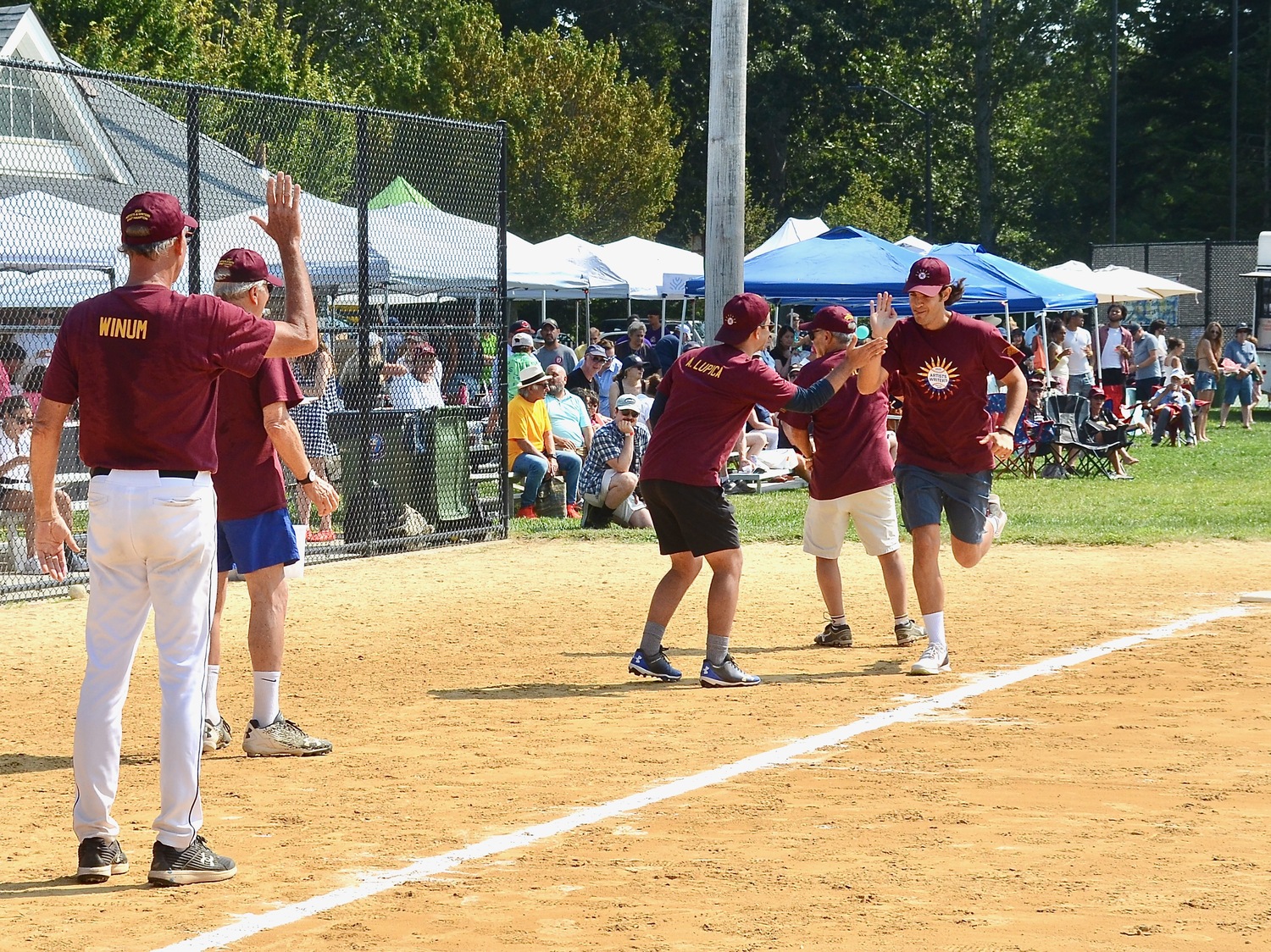 Ted Jones is congratulated by Alex Lupica as he rounds third base after his home run.  KYRIL BROMLEY