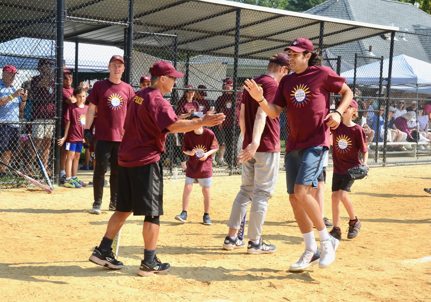 Ted Jones is congratulated at home plate by Dan Pulick as he touches home plate after his home run.  KYRIL BROMLEY