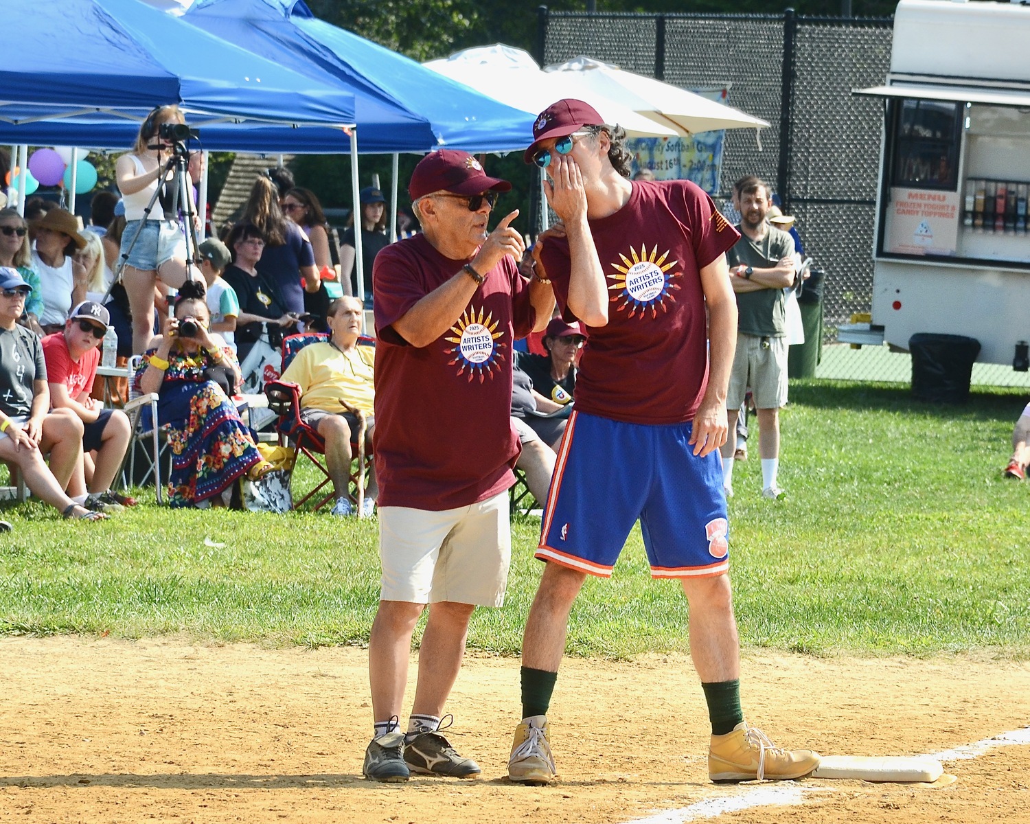 Mike Lupica discusses strategy with a runner on third base.  KYRIL BROMLEY