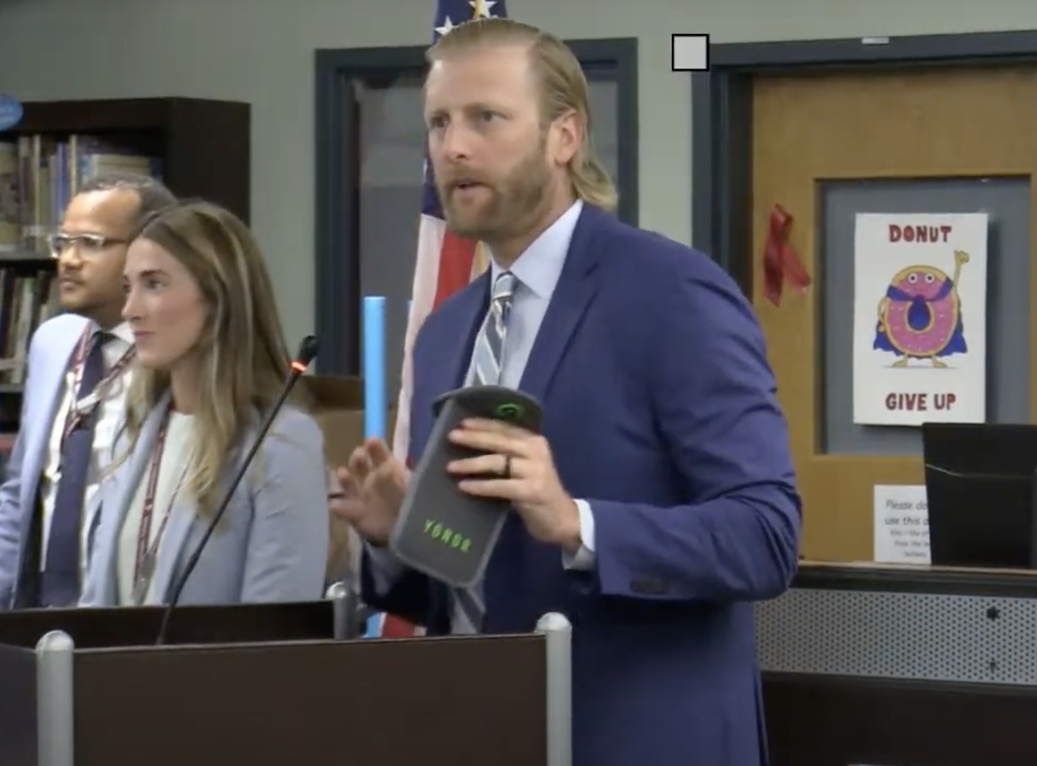 Southampton Intermediate School Assistant Principal Dr. Nick Epley shows a portable Yondr pouch unlocking magnet to the Board of Education.