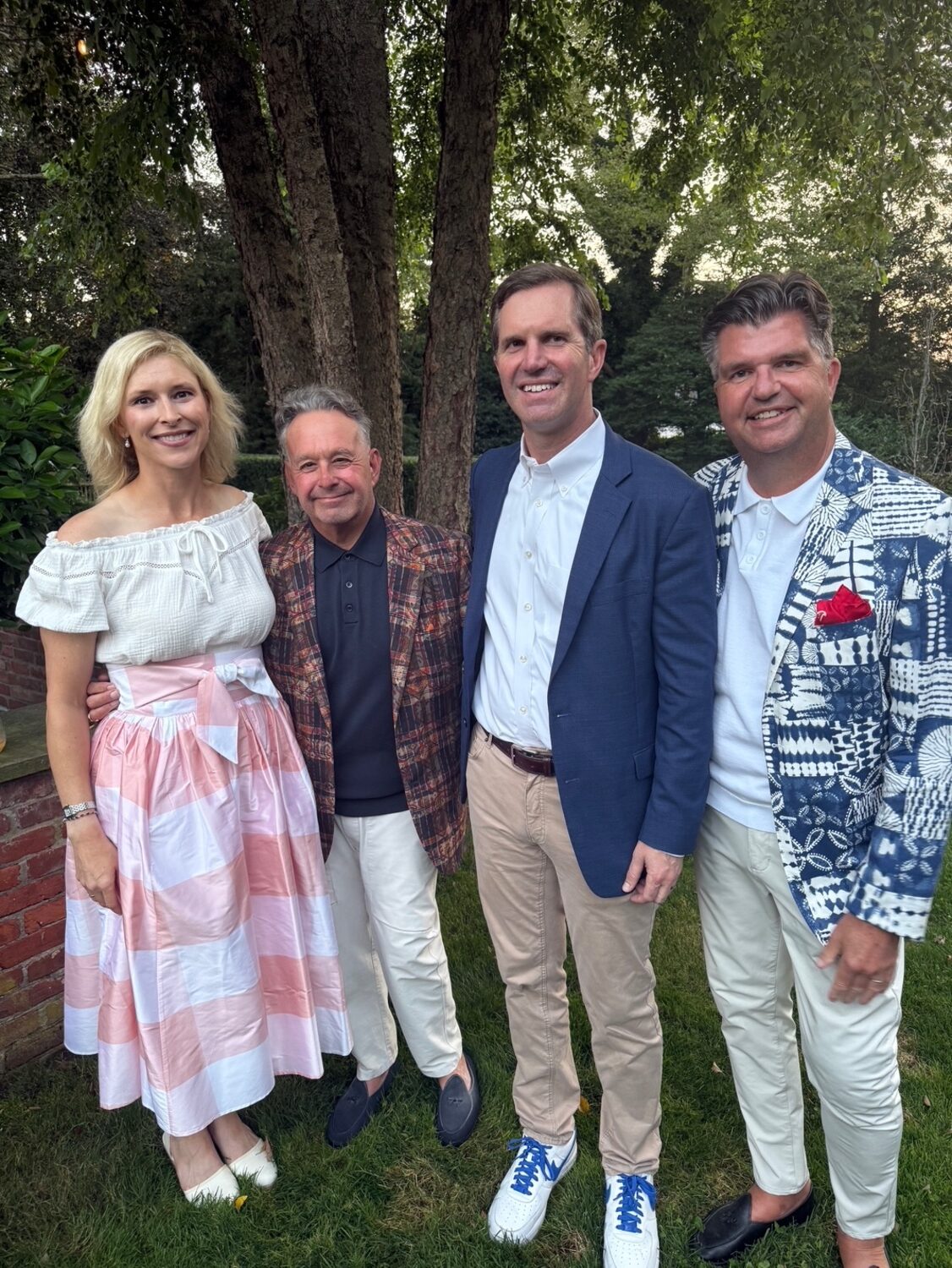 As part of their barely more than 24 hour swing through the Hamptons, KY Gov. Andy Beshear and wife Britainy were feted at a cocktail party in the garden of Rob Coburn and Averitt Buttry’s Hill Street home along with co-hosts Lizzz Kritzer, Danielle Lise Desrochers, Steven Stolman and Rich Wilkie. From left, Britainy Beshear, Steven Stolman,  Governor Andy Beshear, Rich Wilkie.  COURTESY STEVEN STOLMAN