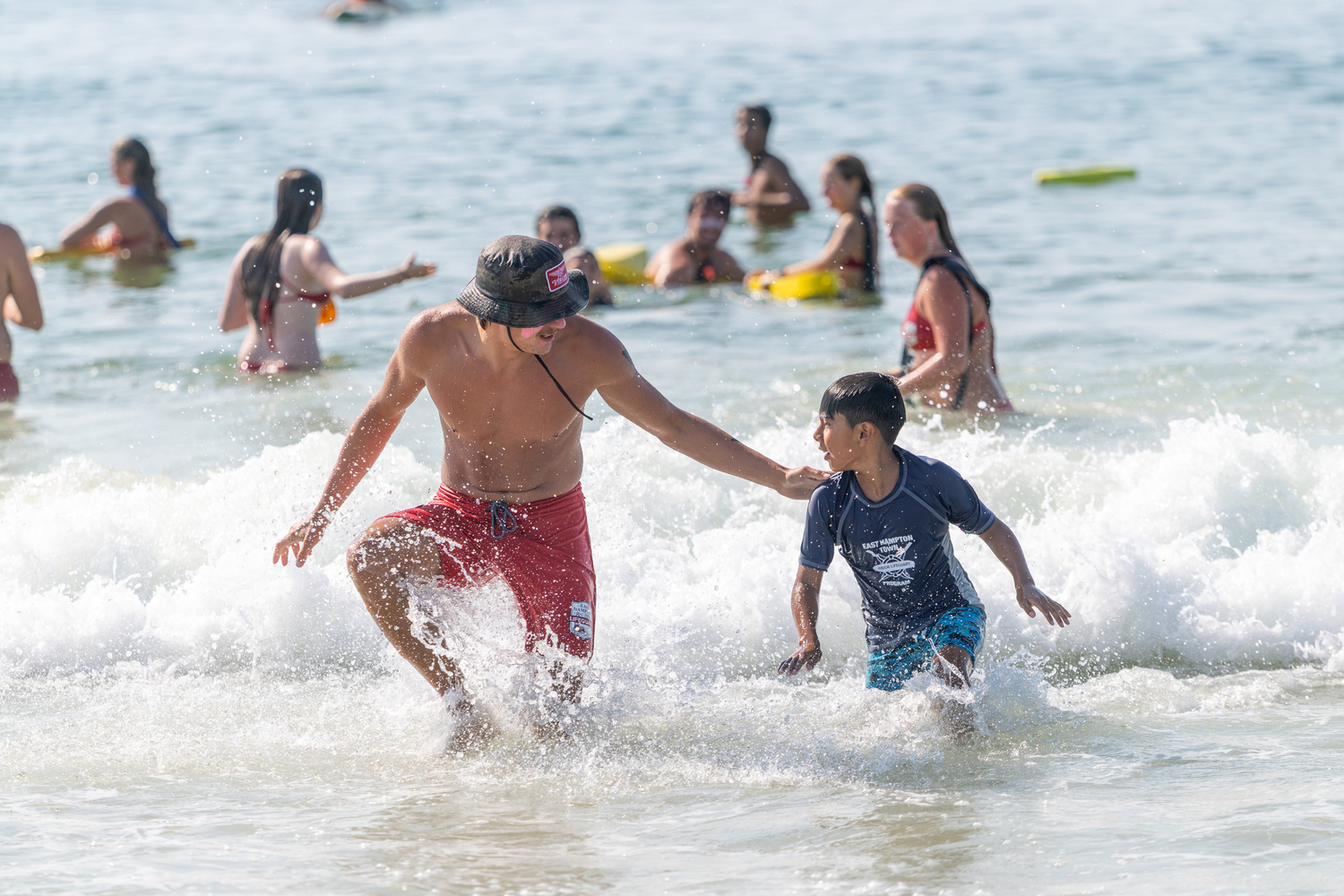 An East Hampton Town lifeguard helps a junior lifeguard.   RON ESPOSITO