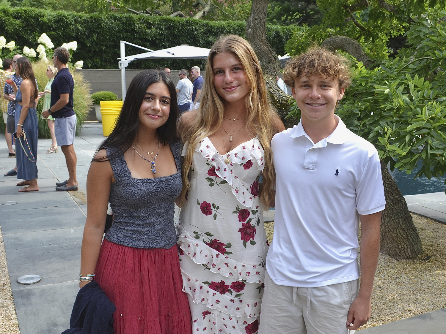 Zoe McDonald, Carli Stuckert and Hudson Tanzmann at the South Fork Sea Farmers benefit at the hone of Kurt Ragovin and Kurt Geihl on Sunday.  KYRIL BROMLEY