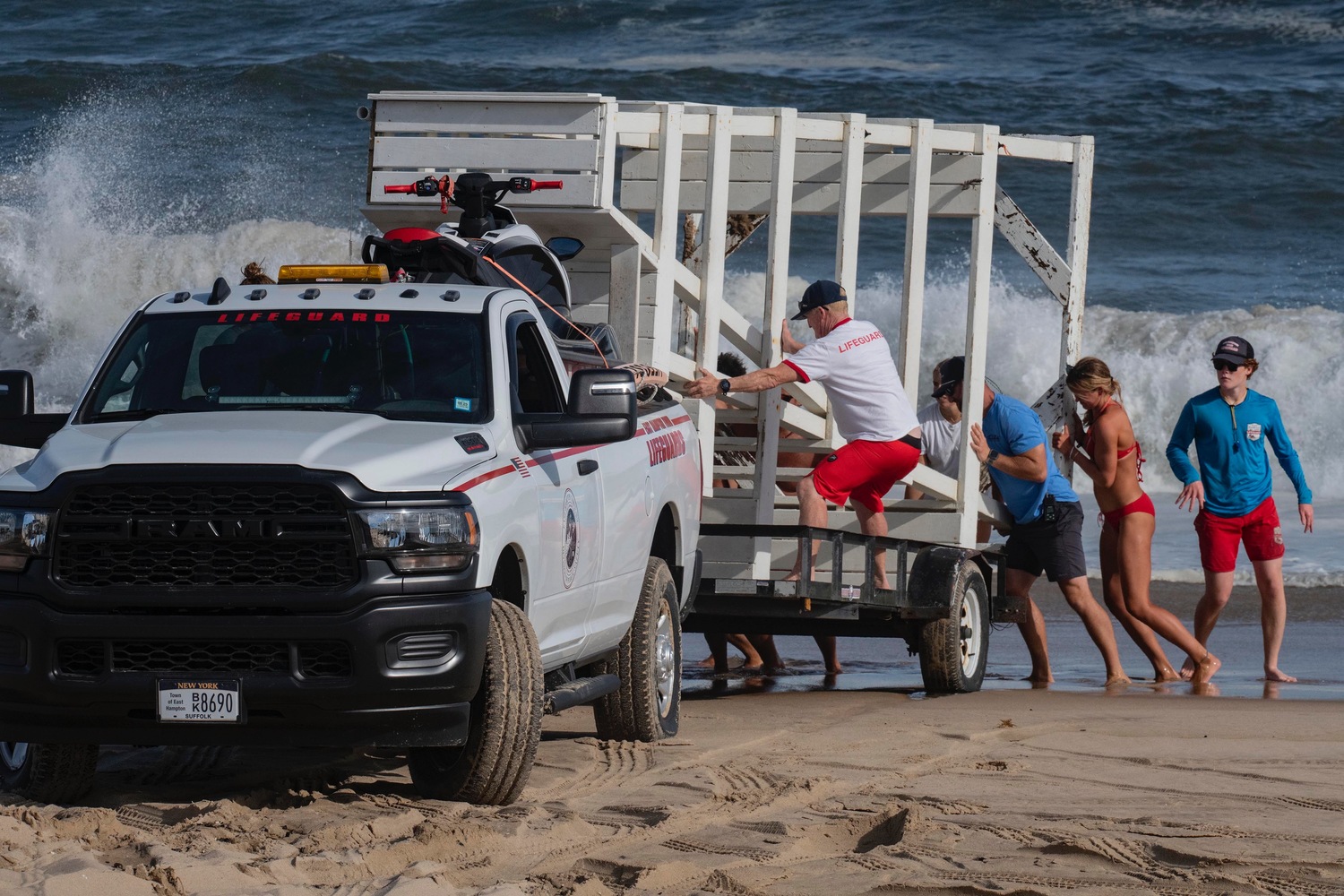 East Hampton Town lifeguards remove the stand from Indian Wells Beach on Tuesday afternoon, in preparation for large swells from Hurricane Erin on Wednesday. Most beaches will be closed to swimming on Wednesday and Thursday as the surf is anticipated to create dangerous rip currents. DOUG KUNTZ