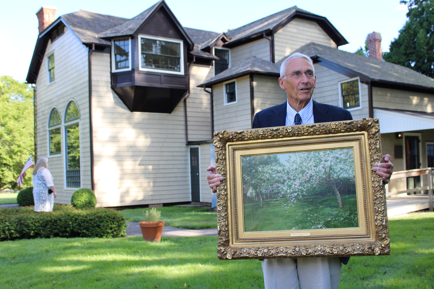 Bob Hefner outside the East Hampton Historical Society's Thomas & Mary Nimmo Moran Studio on Main Street. Hefner was bringing the painting inside to unveil it before a crowd. JACK MOTZ