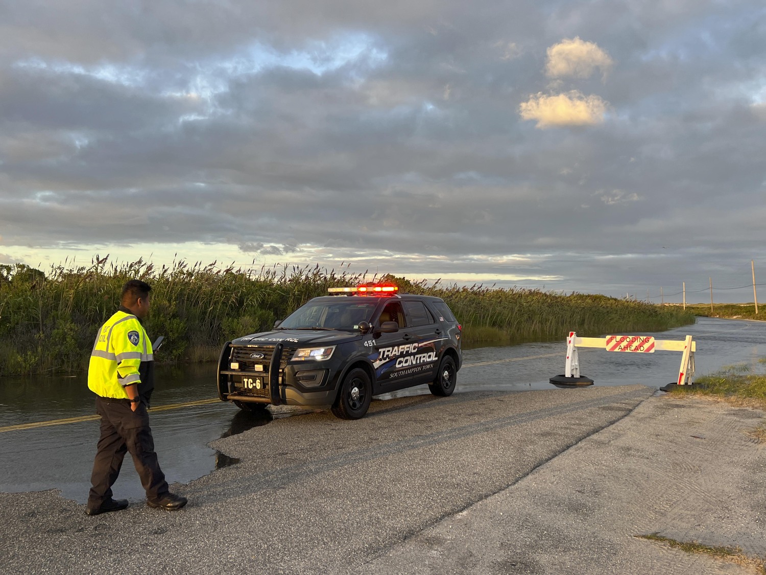Dune Road was shut down in both directions at the Ponqougue Bridge and was already beginning to flood as the tide came in on August 21.  DANA SHAW