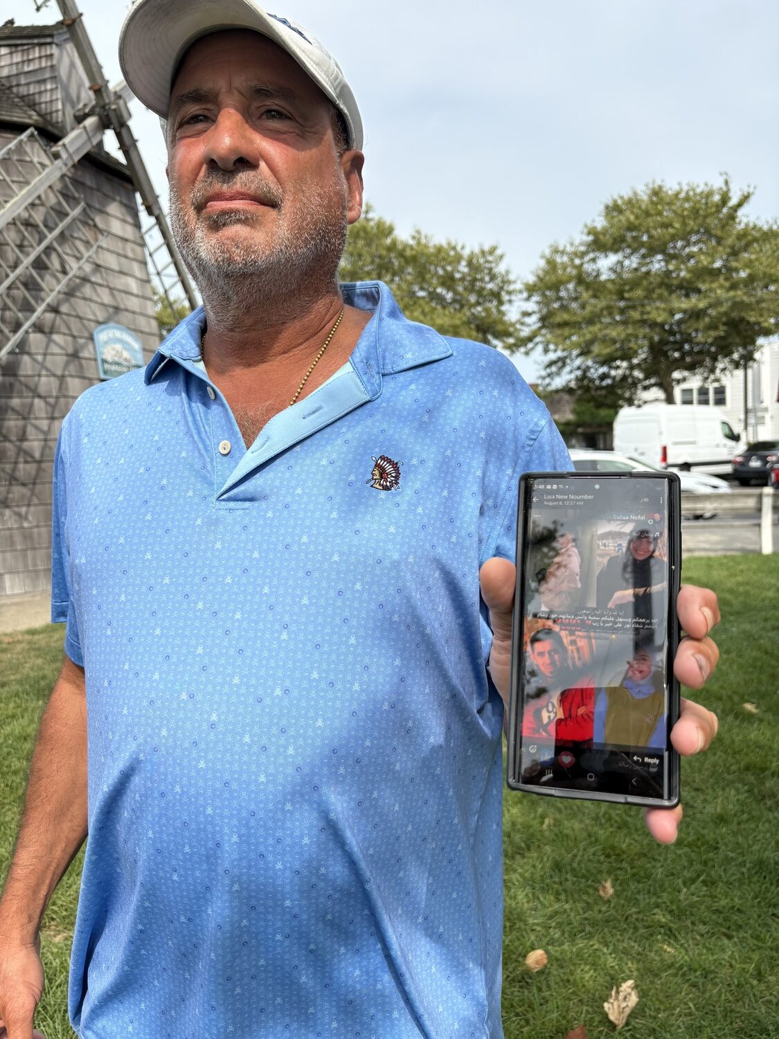 Water Mill resident Joe Gagliardo, showing pictures of the family members of his son-in-law, who were killed in the war in Gaza. CAILIN RILEY PHOTOS
