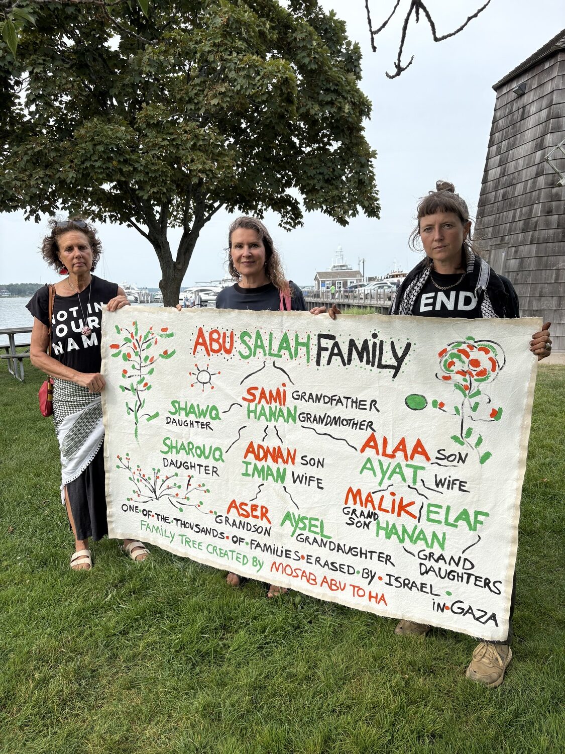 From left, Kathy Engel, Saskia Friedrich and Ella Engel-Snow, with a banner made by Friedrich with the names of a Palestinian family, all of whom were killed in Gaza. CAILIN RILEY PHOTOS