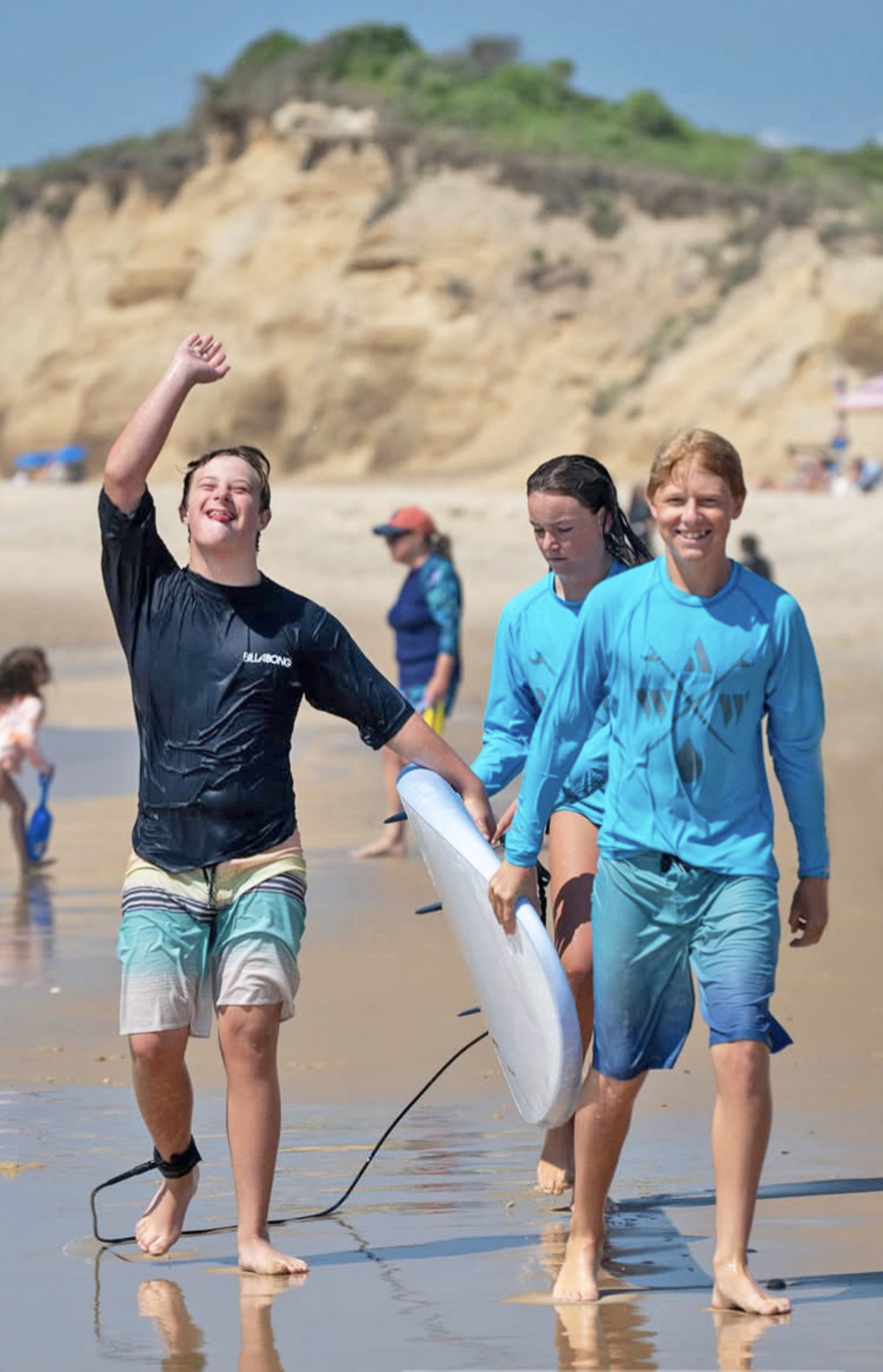 Shane Hartstein, left, sharing the stoke of surfing with other local kids.  COURTESY BOB MILLER