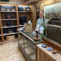 Kelly Bailey behind the counter at her new leather goods and mercantile shop, CoCo & Cat, in the Bridgehampton Commons shopping center. STEPHEN J. KOTZ