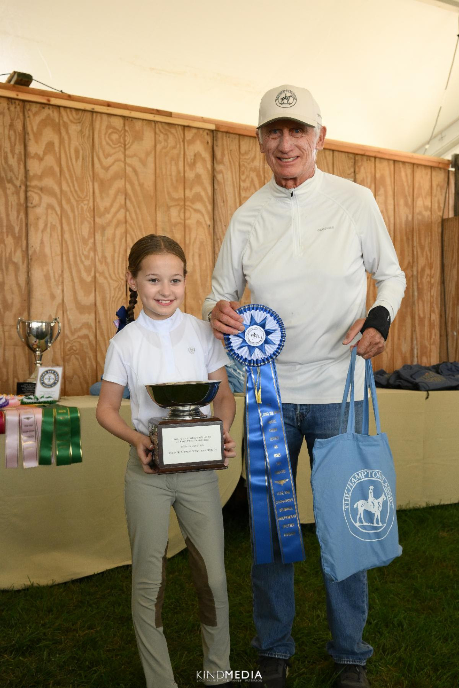Kenzie Pu-Folkes of Great Neck, left, with Olympic double-golf medalist Joe Fargis. Kenzie returned to the Hampton Classic winner’s circle this year for top honors in the Advanced Independent division aboard HorseAbility Inc.’s Black Magic.  KIND MEDIA