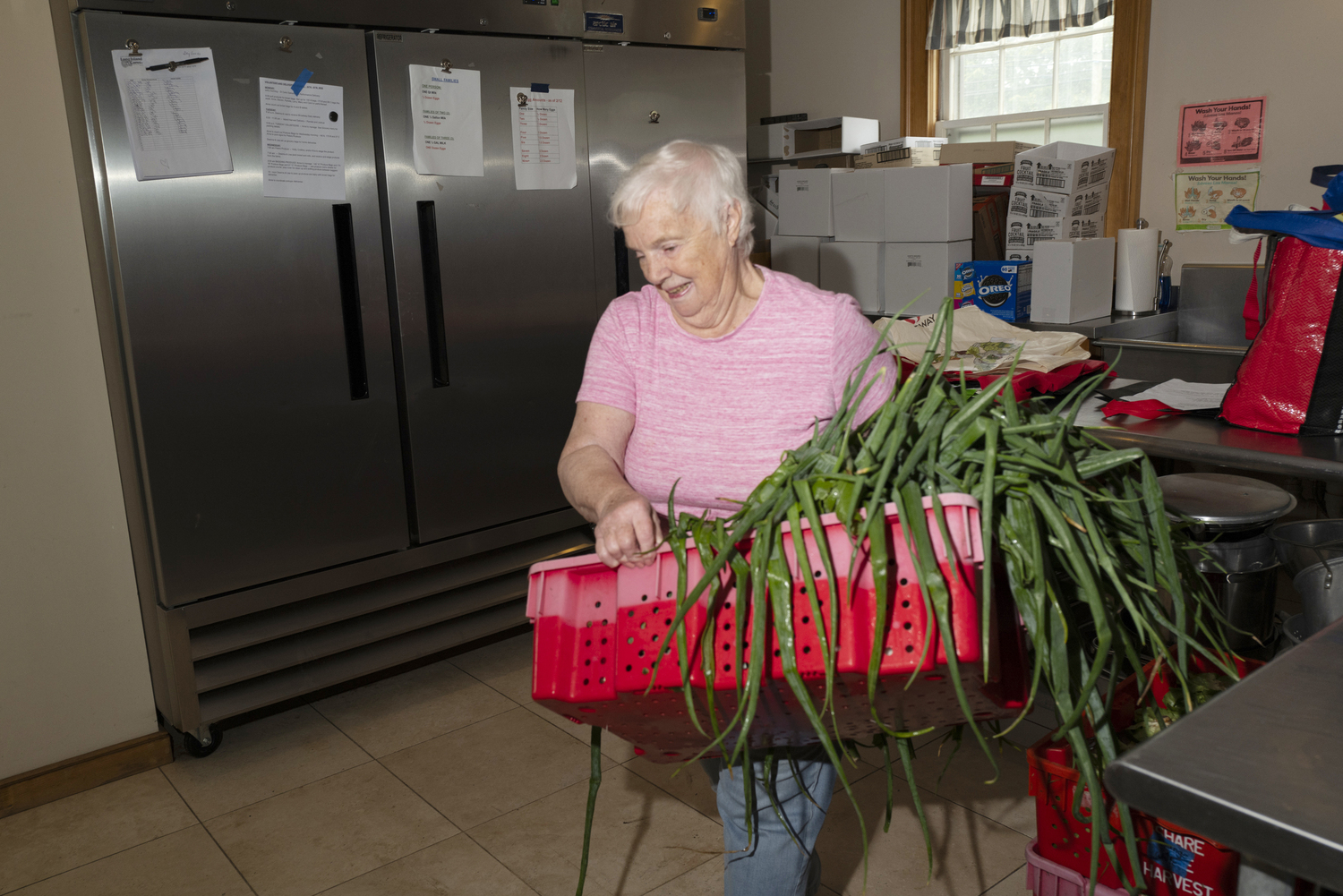 Deanna Tikkanen, a volunteer at the Springs Food Pantry, receives produce from Share the Harvest. LORI HAWKINS