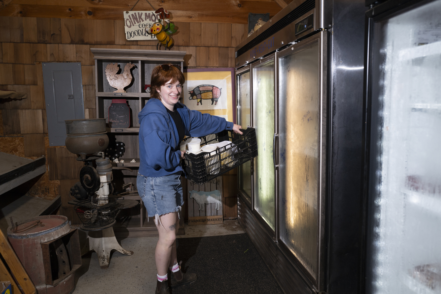 Sophie Flax picking up dairy products from Goodale Farms in Riverhead. Share the Harvest Farm stand curates a selection of local produce, artisanal baked goods, dairy products and grass-fed meats. LORI HAWKINS