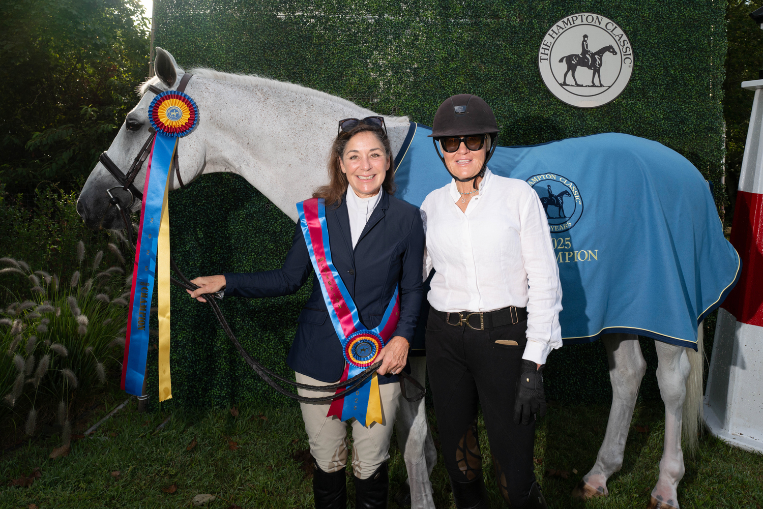 Anne Byers of Locust Valley, left, with her trainer Laura Bowery/Sea Aire of Southampton. Byers was champion in the Adult Amateur Owner Division, and also Overall Grand Champion of Locals Day with her mount Rocklyn at the Hampton Classic on Sunday.  LORI HAWKINS