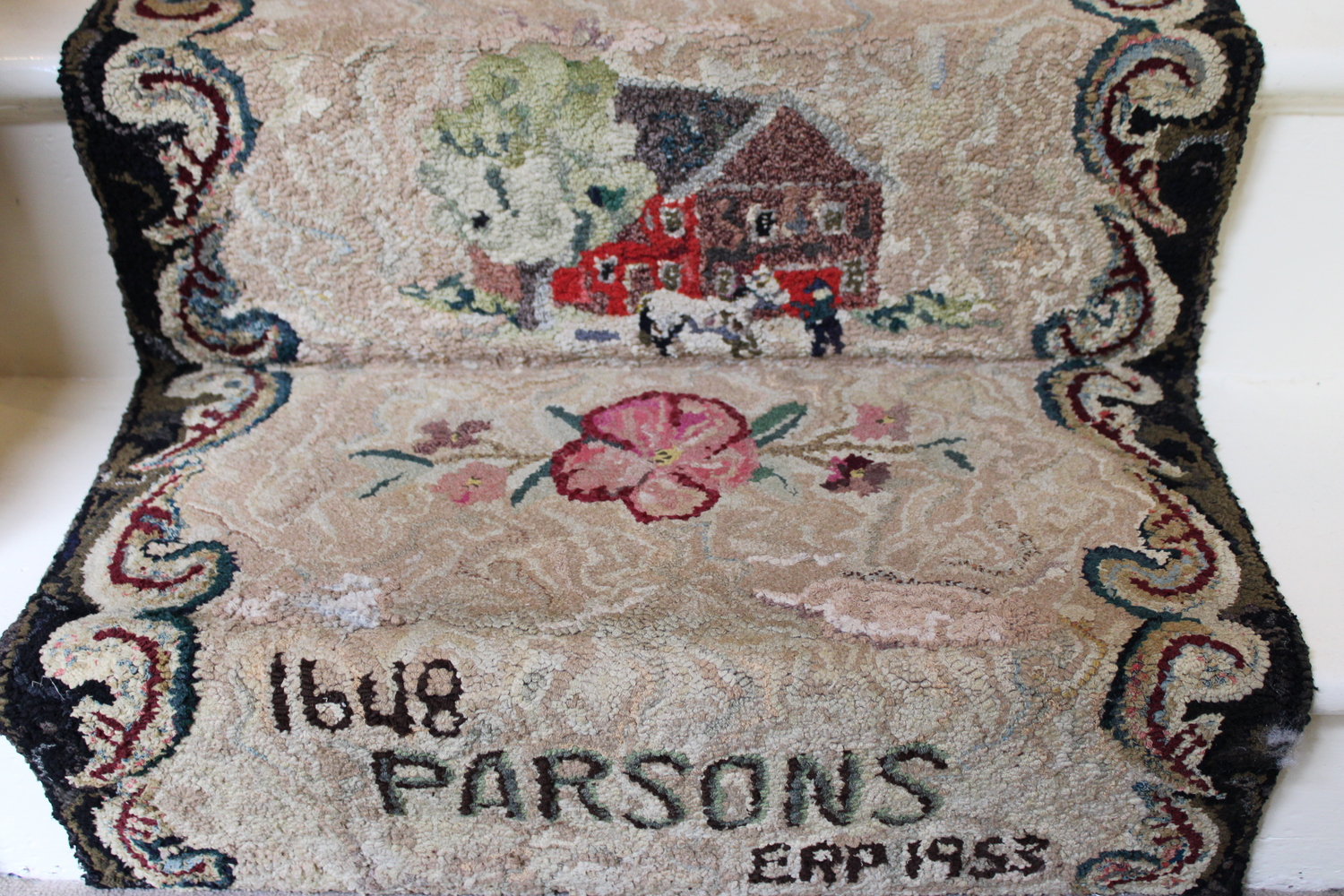 A piece of the rug reading 