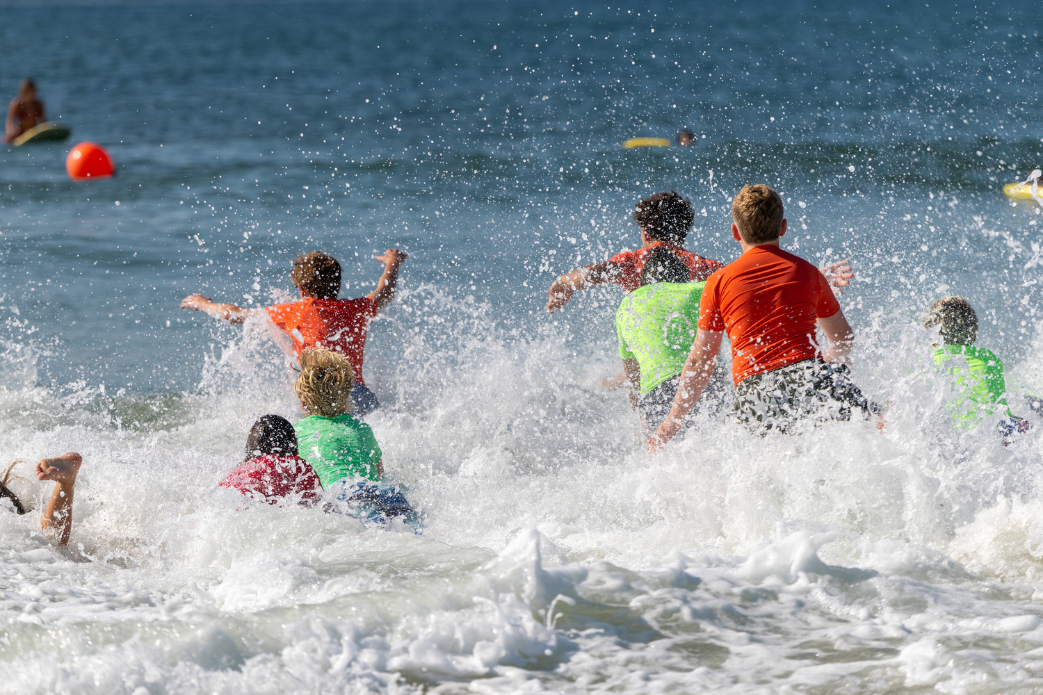 Junior lifeguards head into the surf at Ponquogue Beach in Hampton Bays on Saturday morning.  RON ESPOSITO