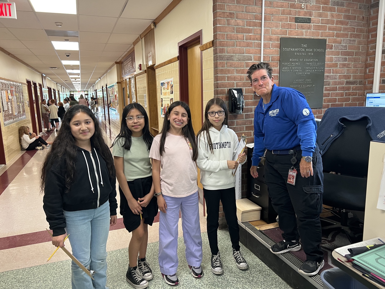 Fourth grade students entering Southampton Intermediate School next year paired up with fifth graders for the annual Buddy Day. The event is a longstanding tradition that gives fourth graders an opportunity to navigate their new school while meeting its staff. From left, fifth-grader Amy Pacheo, fourth-grader Samantha Gonzalez, fifth-grader Alexandra Alfaro and fourth-grader Joselyn Juarez, and security guard Marty Weinhardt. The student buddies attended classes, enjoyed lunch in the SIS cafeteria and took part in a scavenger hunt to help orient the incoming students to the building. Fourth graders also participated in a Skate Night with their parents and an open house. COURTESY SOUTHAMPTON SCHOOL DISTRICT