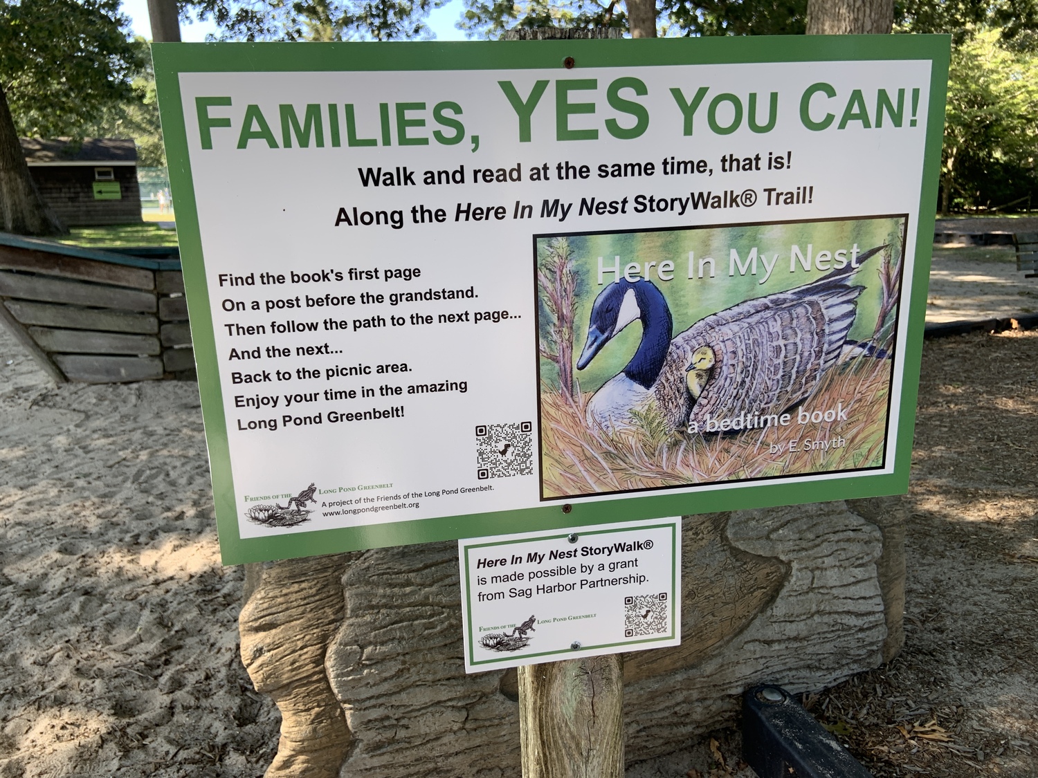A sign in the Mashashimuet Park playground directs people to the StoryWalk trail. STEPHEN J. KOTZ