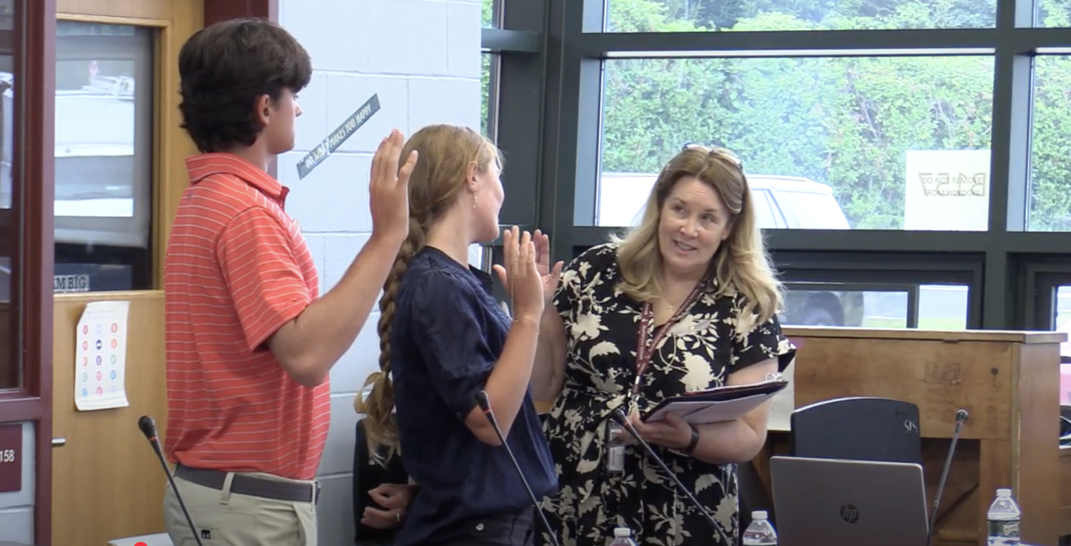 Southampton School District Clerk Amy Pierson swears in the Board of Education's ex-officio student members Noah Kent and Mateya Silvera.