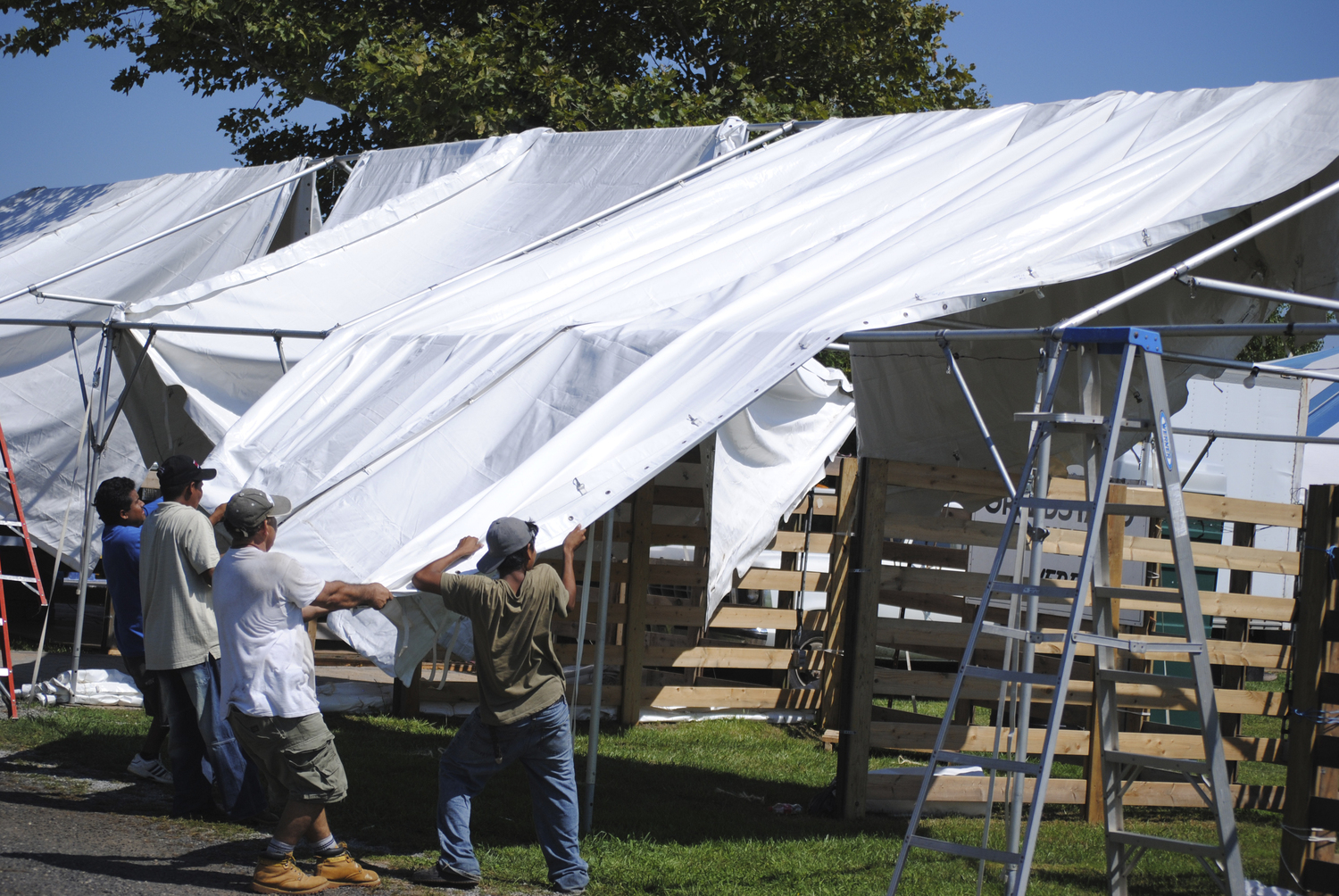 Crew members at the 36th annual Hampton Classic Horse Show take the roof off one tents on the west side of the grounds in Bridgehampton in anticipation of Hurricane Irene’s arrival on august 26, 2011.   FILE PHOTO