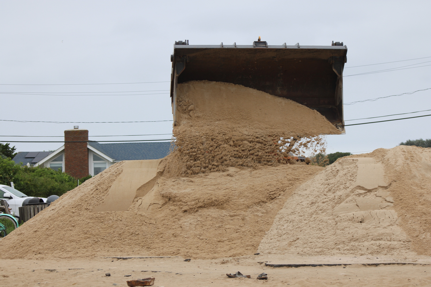 At Ditch Plains, trucks piled up sand in preparation for Hurricane Erin on Wednesday, August 20. The hurricane stayed offshore but stirred up the ocean. Councilman David Lys was onsite giving some direction. JACK MOTZ