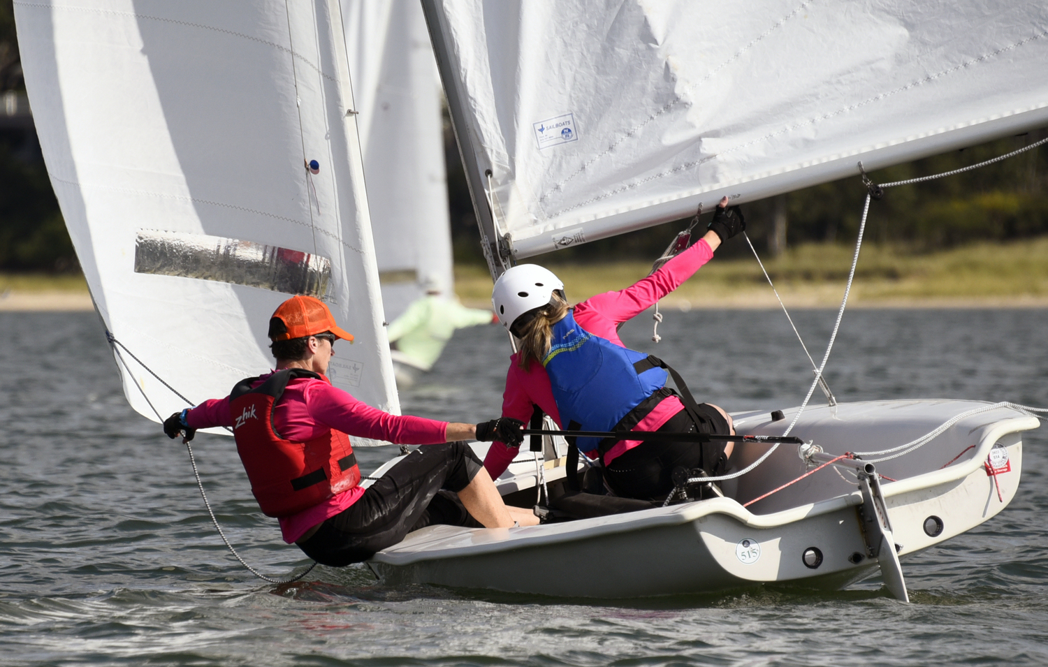 “Wing and Wing” jib and mainsail on opposite sides of the boat when sailing downwind, demonstrated here by Sinéad FitzGibbon and Jenn Theiss.  MICHAEL MELLA