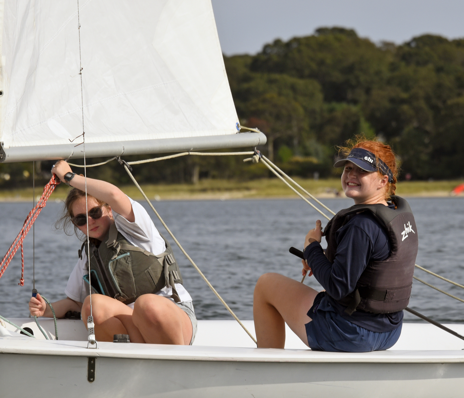 It’s all smiles for overall winner Venetia Satow as Ava Kenny keeps the mainsail in place to avoid an accidental jibe while sailing to the leeward mark.  MICHAEL MELLA
