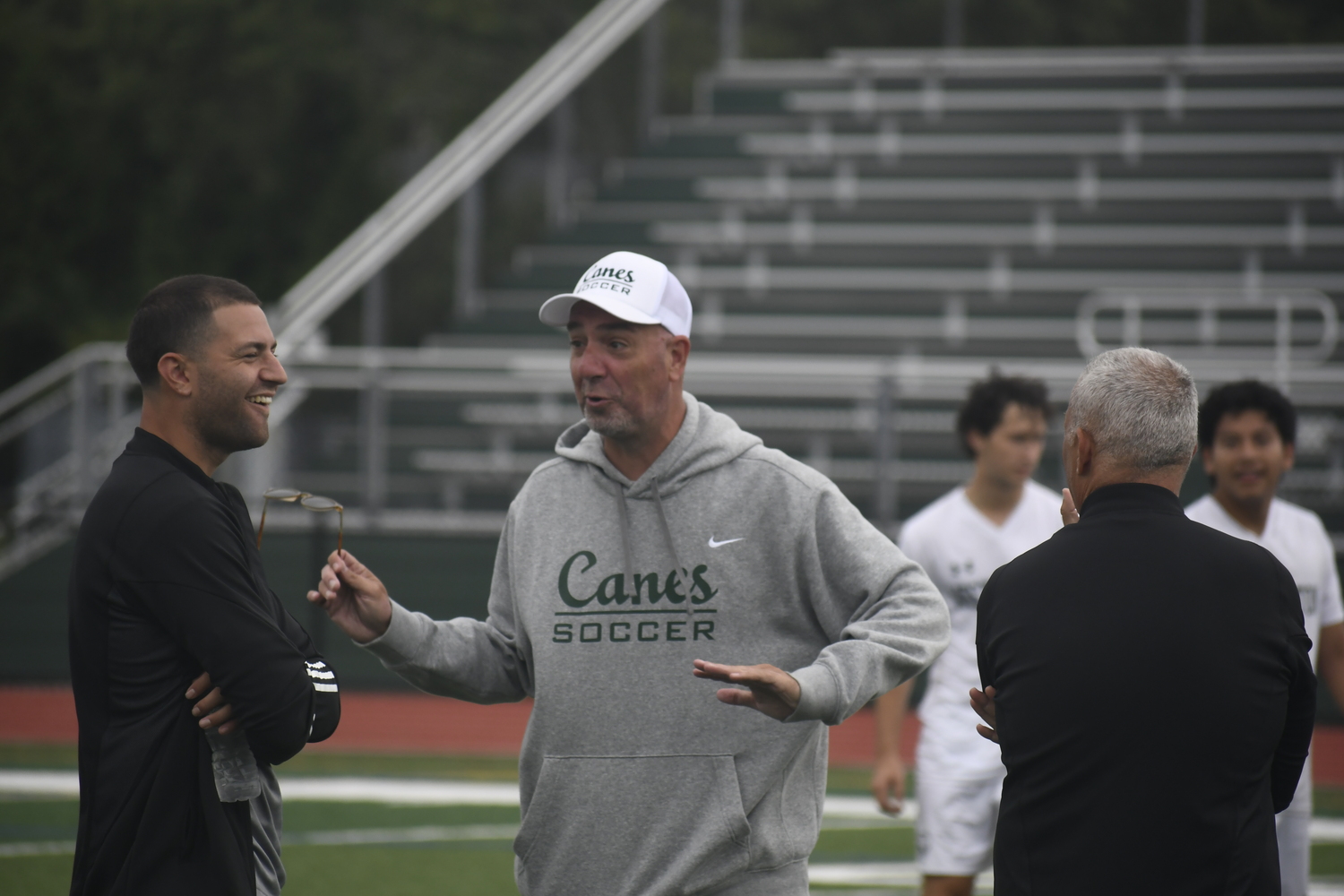 Eric Bielski shares a laugh with Anthony Sunderman and John Paga prior to Monday's scrimmage.  DREW BUDD