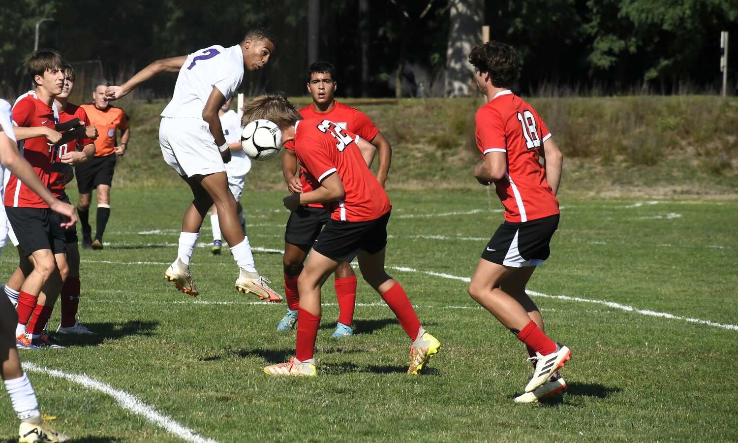 Pierson junior defender Locklin Beard clears the ball out of his defensive end with his head.  DREW BUDD