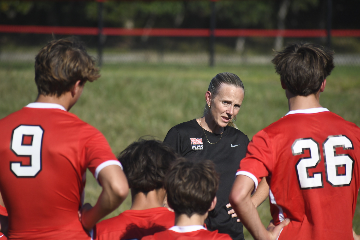 Pierson head coach Haley Luzim talks with her team during halftime of their game on Thursday, September 11.  DREW BUDD