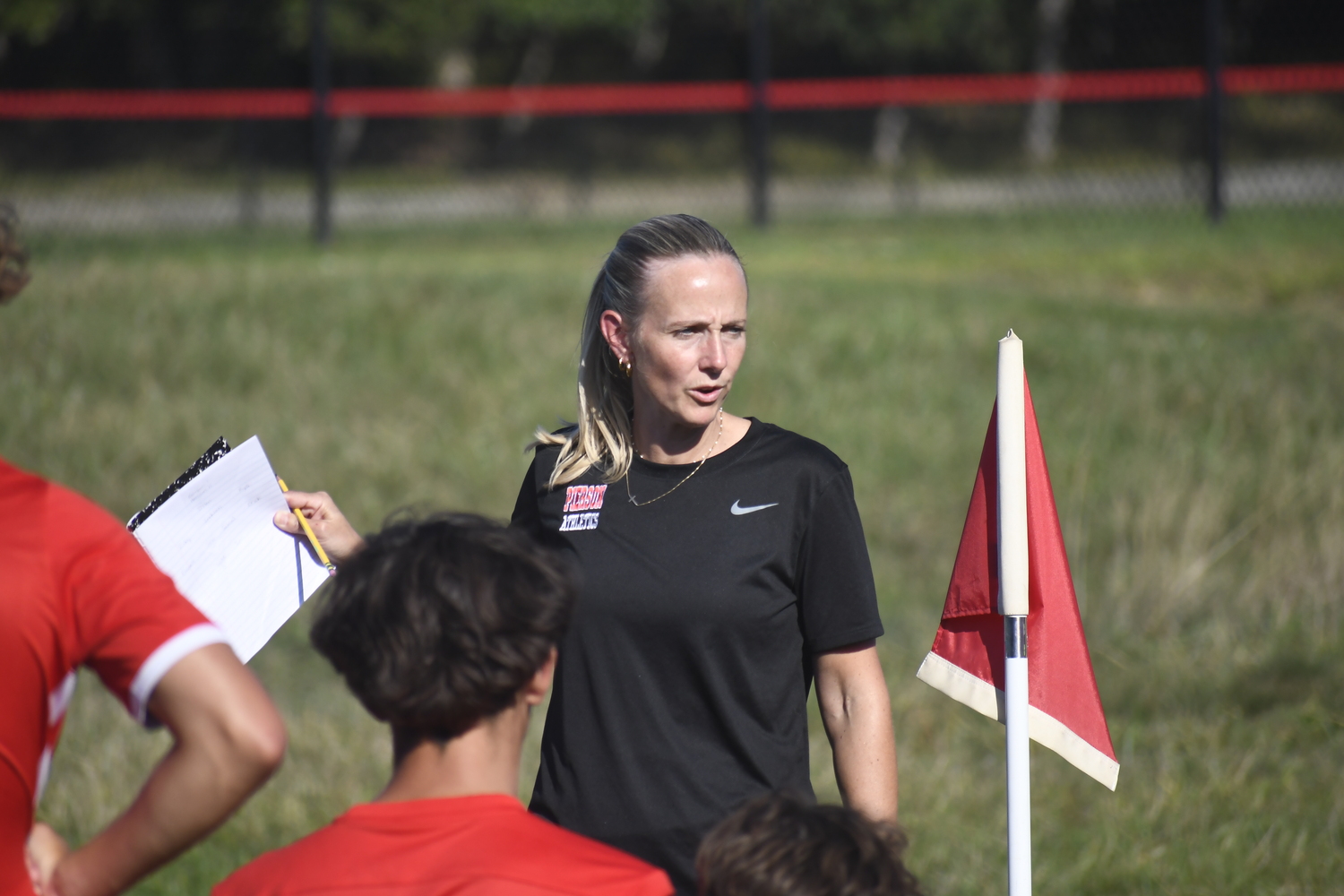 Pierson head coach Haley Luzim talks with her team during halftime of their game on Thursday, September 11.  DREW BUDD