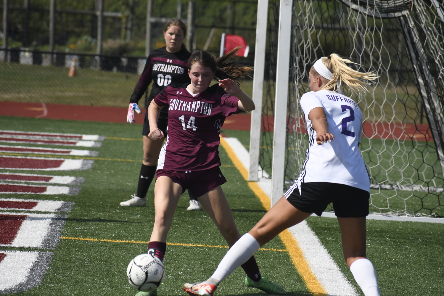 Southampton junior Riley Cameron gets to the ball before Sayville senior Sophia Buffardi.  DREW BUDD