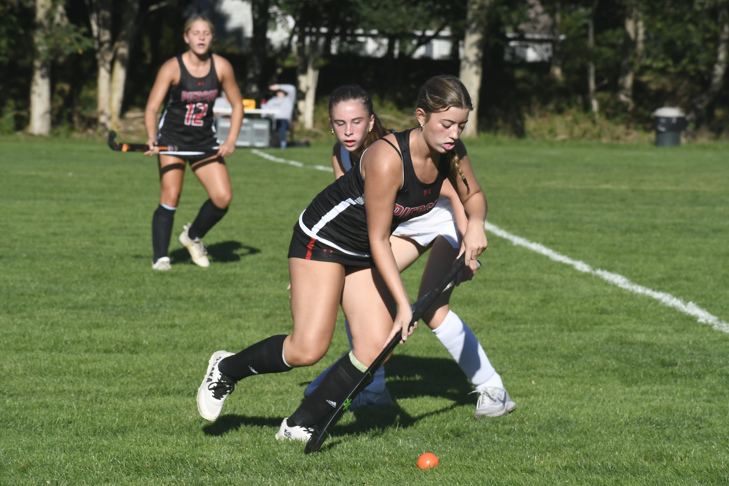 Pierson junior Ashley Stuckart races by an East Islip player.  DREW BUDD