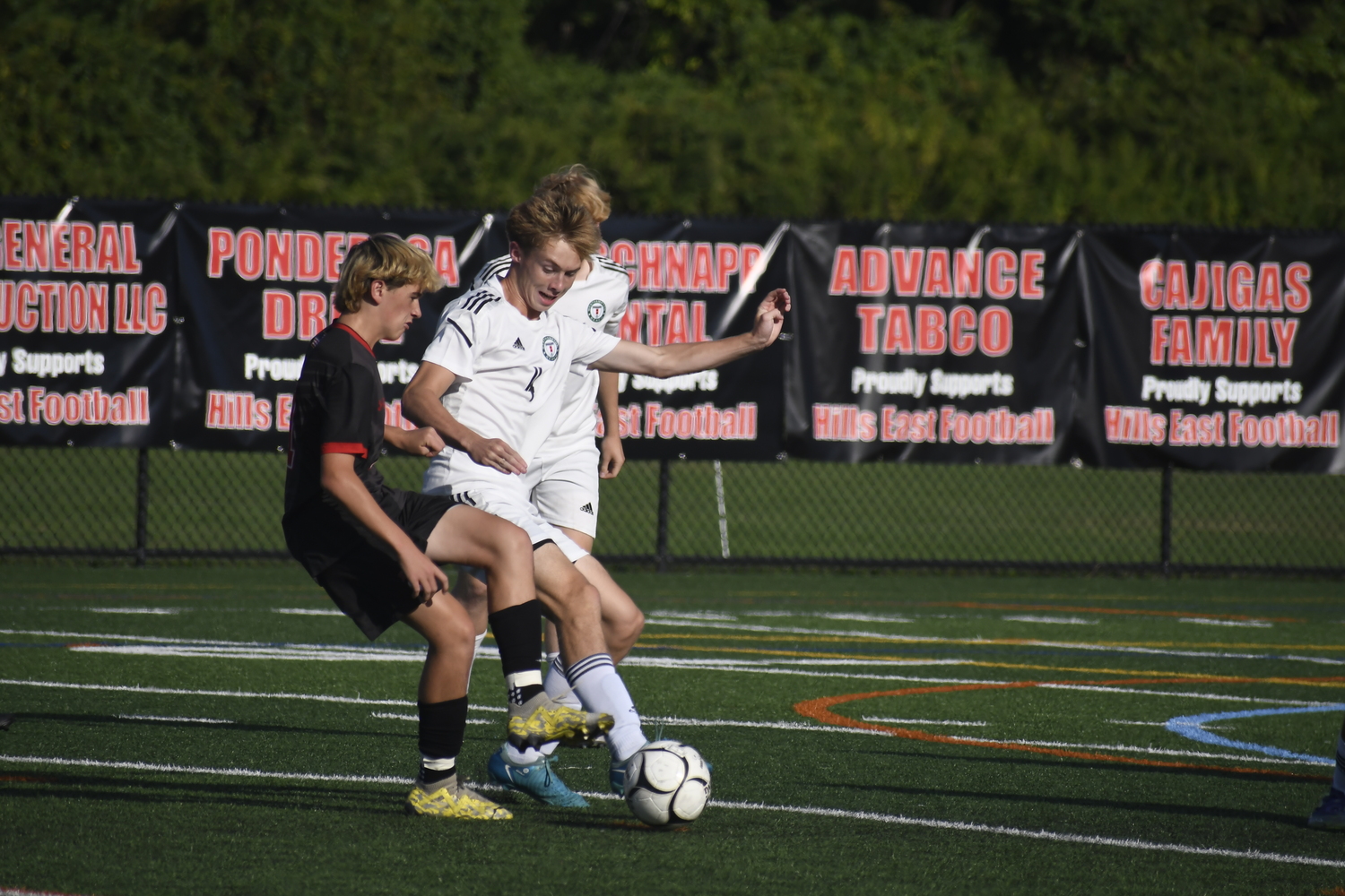 Westhampton Beach senior Anthony Atkinson gets to the ball before an East Islip player.  DREW BUDD