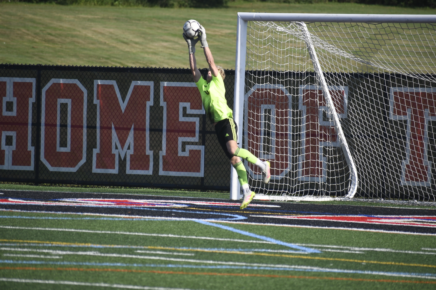 Westhampton Beach junior Nate Cangelosi stretches out to make a save.  DREW BUDD