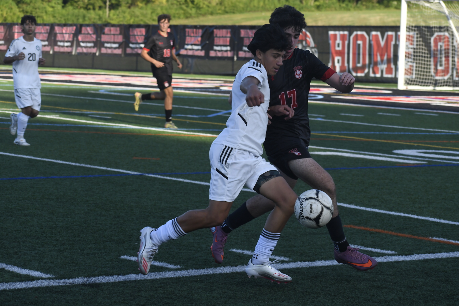 #2 and Hills East sophomore Caden Merlis battle for the ball. DREW BUDD