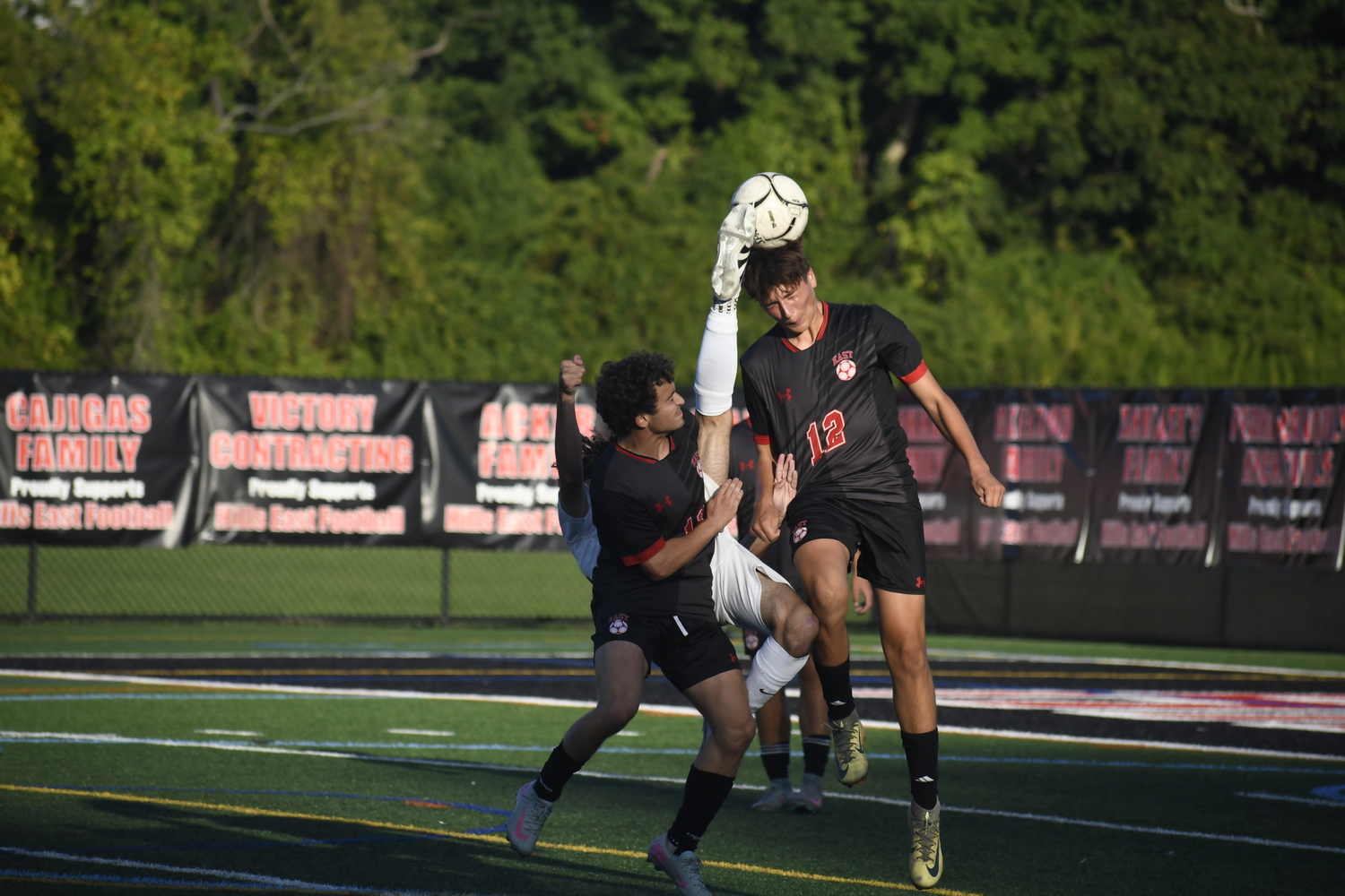 Angelo Melendez? tries a bicycle kick to get the ball forward as sophomore NIcholas Pannella heads the ball.  DREW BUDD