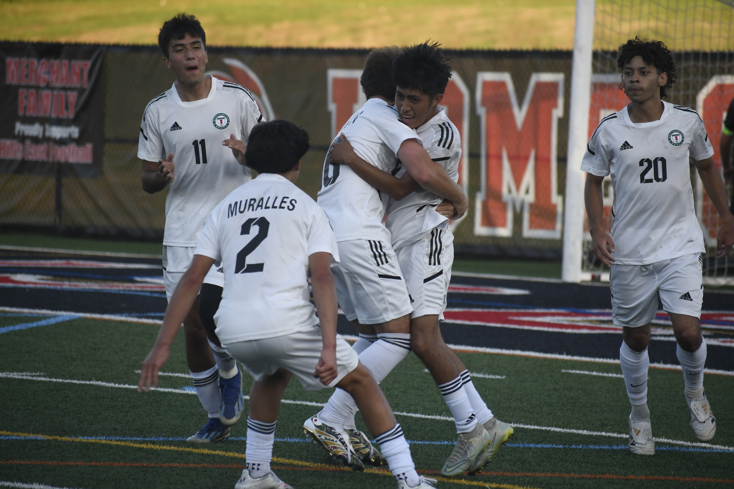 Tito is mobbed by his Hurricane teammates after his goal tied the game, 2-2, in the second half on Friday.  DREW BUDD