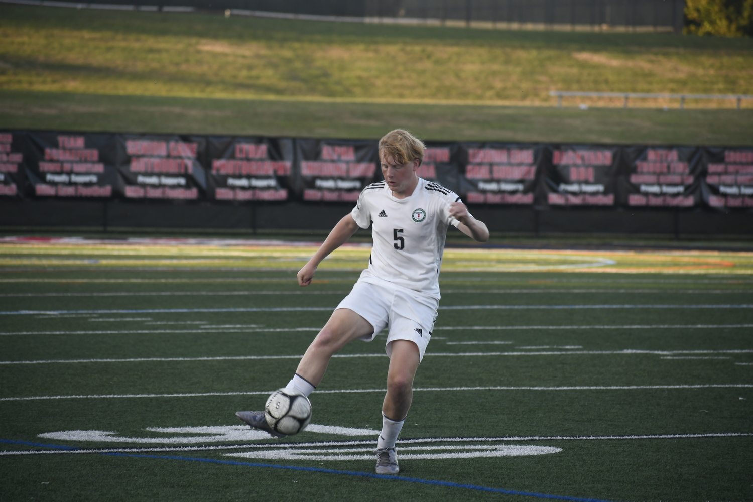 Westhampton Beach senior Charles Schwenker sends a free kick upfield.  DREW BUDD